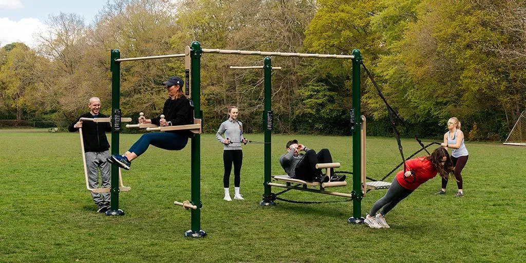 Participants mirroring torso angles during an outdoor warmup